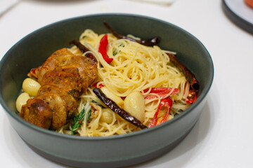 Spaghetti with Northern Thai spicy sausage on white background.