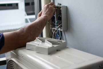 Technician  install  air conditioner outdoor unit