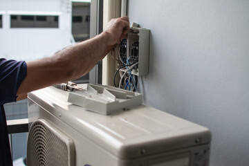 Technician  install  air conditioner outdoor unit