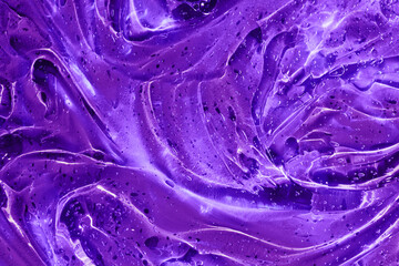 Full frame neon purple, violet holographic transparent cosmetic gel serum background texture, smudge slime with drips and bubbles. Abstract surreal psychedelic jelly backdrop.