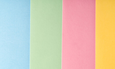 Fototapeta premium Multi colored abstract paper of pastel blue,pink,yellow,green colors palette, with geometric shape, flat lay.