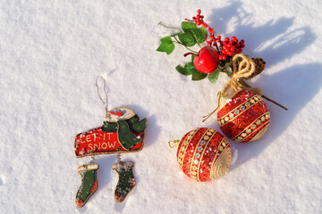 Festive Christmas ornaments and decorations over natural snow background.