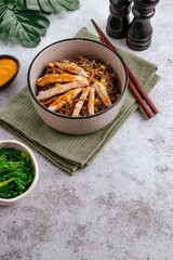 Asian buckwheat noodles with vegetables, sauce and chicken in a bowl