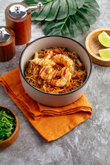 Traditional Asian noodles with vegetables, sauce and shrimp