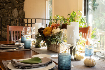 Festive Thanksgiving tablescape, with candles and flowers.