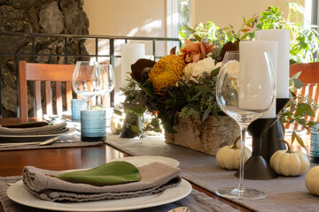 Festive Thanksgiving tablescape, with candles and flowers.