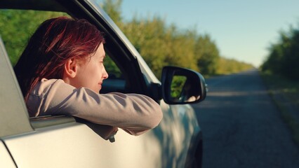 girl rides car with her hand out window, breeze your hair, wind face, cars summer day, hand...