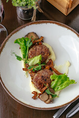 meatballs fried on a plate with potatoes and vegetables