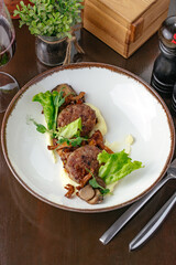 meatballs fried on a plate with potatoes and vegetables