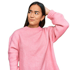 Young asian woman wearing casual winter sweater confuse and wondering about question. uncertain...