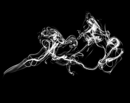 Abstract white puffs of smoke swirl overlay on black background pollution. Royalty high-quality free stock photo of abstract smoke overlays on backgrounds. Black smoke swirls fragments