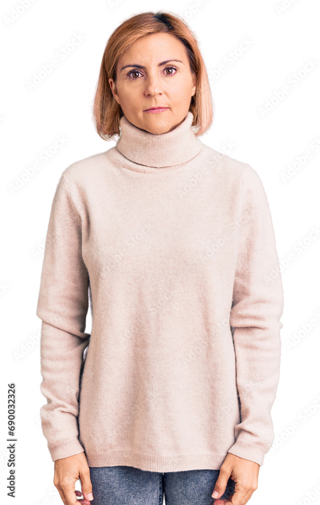 Sticker Young blonde woman wearing casual clothes with serious expression on face. simple and natural looking at the camera.