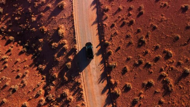 Driving a modern car in Monument Valley. Top view red rock sandstone desert landscape in Utah.