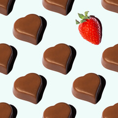 Seamless pattern of heart-shaped chocolates and red ripe strawberries with a shadow on a blue background. Favorite food background. A symbol of love. Valentine card.