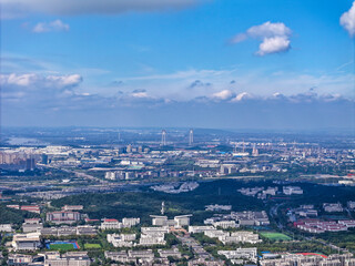 Aerial photography of green city, urban buildings, livable environment, blue sky and white clouds