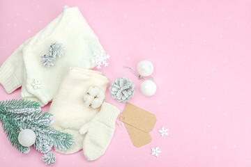 Cozy winter composition. Knitted mittens, warm scarf, traditional Christmas decoration