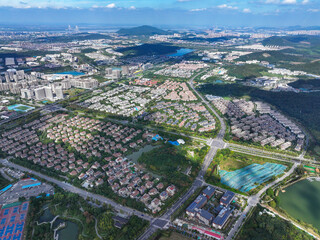 Aerial photography of green city, urban buildings, livable environment, blue sky and white clouds