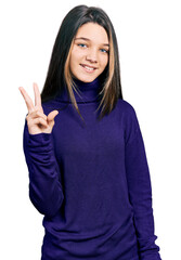 Young brunette girl with long hair wearing turtleneck sweater showing and pointing up with fingers number two while smiling confident and happy.