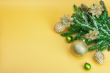 Traditional New Year composition. Festive decor, snowy Christmas tree branches, balls, flowers