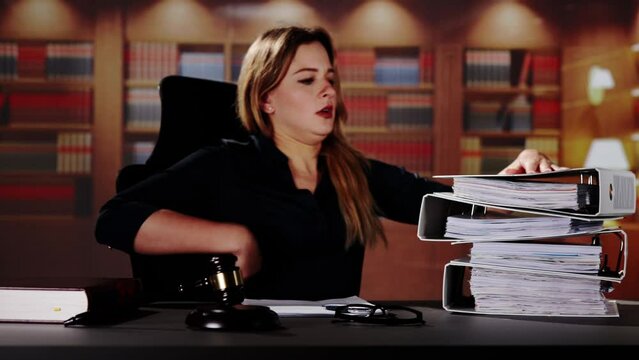 Midsection Of Female Lawyer Carrying Stack Of Ring Binders