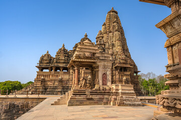 Fototapeta na wymiar The Khajuraho Group of Monuments are a group of Hindu and Jain temples Khajuraho Temple, popular worldwide for its outstanding temples designs and erotic sculpture. It is a UNESCO world Heritage site.