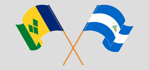 Crossed and waving flags of Saint Vincent and the Grenadines and Nicaragua - obrazy, fototapety, plakaty