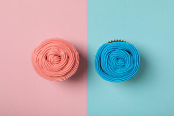 Cupcakes on blue and pink background, top view