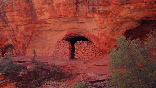 Ancient Red Rock Shelter Ruins Nestled in Cliffside