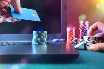 Casino game player betting online with laptop