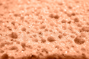 Color peach fuzz sponge perforated texture background