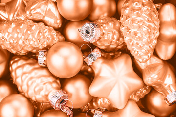 Peach Christmas baubles background. Color trend of the year.