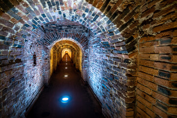 An ancient brick tunnel in the dungeon of the fortress.