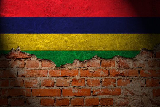 A wall with a painting of the mauritius flag at night.