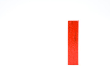 Red wooden block standing isolated on a white background.