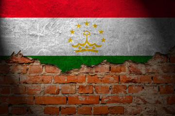 A wall with a painting of the tajikistan flag at night.