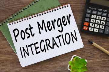 Post Merger Integration. dark work desk. text on page