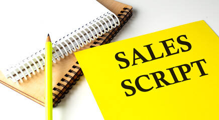 SALES SCRIPT text written on yellow paper with notebook