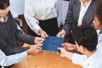 Corporate officer worker collaborate in office, connecting puzzle pieces with report paper on table...