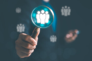 Human resource management concept. man using a magnifying glass searching for employees to teamwork