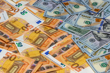 50 euro and 100 dollar bills scattered on the table as a background 13