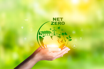 Net zero icon in hand on green background. Net zero for environmental, social, sustainable and ethical. clean energy icon around it. Net zero emission Idea innovative carbon neutrality in 2050.