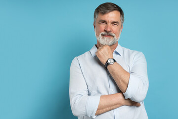 Portrait of happy casual older man smiling, Mid adult, mature age male with gray hair, Isolated on blue background - Powered by Adobe