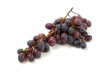 Bunch of organic black grapes isolated on white background.