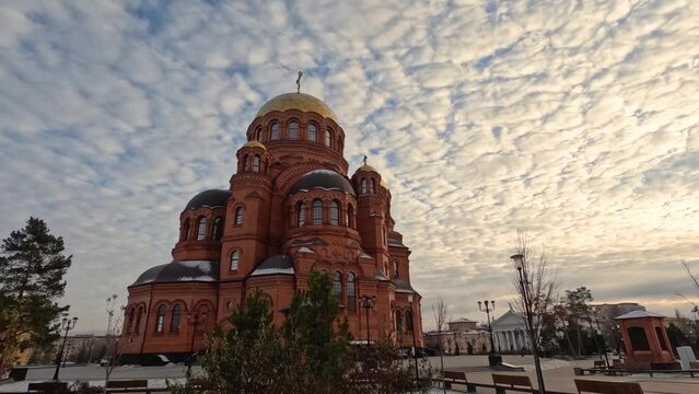 Orthodox Cathedral of Alexander Nevsky Volgograd, Russia - December 7, 2023. A static shot of the cathedral on a sunny day against the backdrop of beautifully floating clouds in the sky. sky time laps