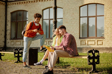 University friends chilling outdoors, young people having nice conversation