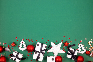 Christmas white gifts boxes, red and white baubles at green background. Christmas background concept