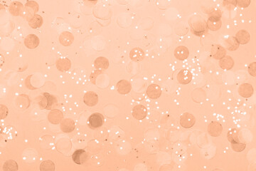 Peach fuzz festive background with confetti.