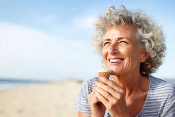 woman eating an ice cream cone at the beach