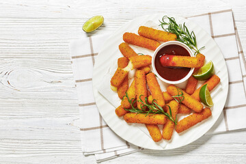 fried mozzarella sticks with sauce on white plate