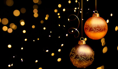 Golden Christmas ornaments on black background with bokeh lights